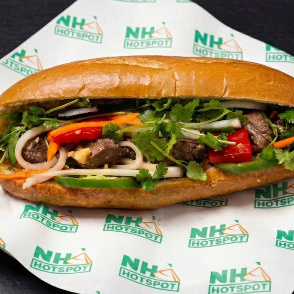 Bánh Mì Bò Lúc Lắc — shaking beef bánh mì with marinated filet mignon, peppers, onions, and pickled vegetables